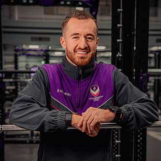 Charlie is smiling for a headshot in Loughborough Sport kit.